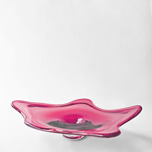 Magenta glass decorative platter with modern design.