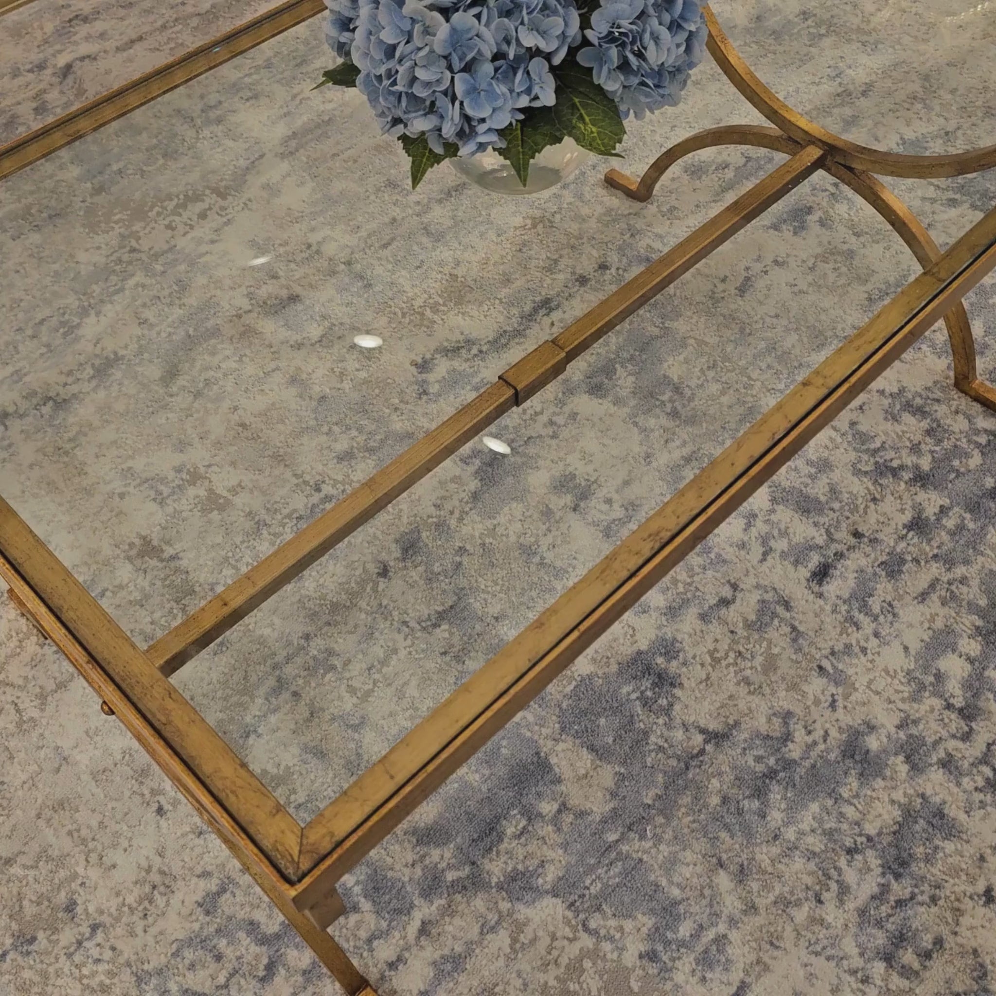 Gold coffee table with glass top.