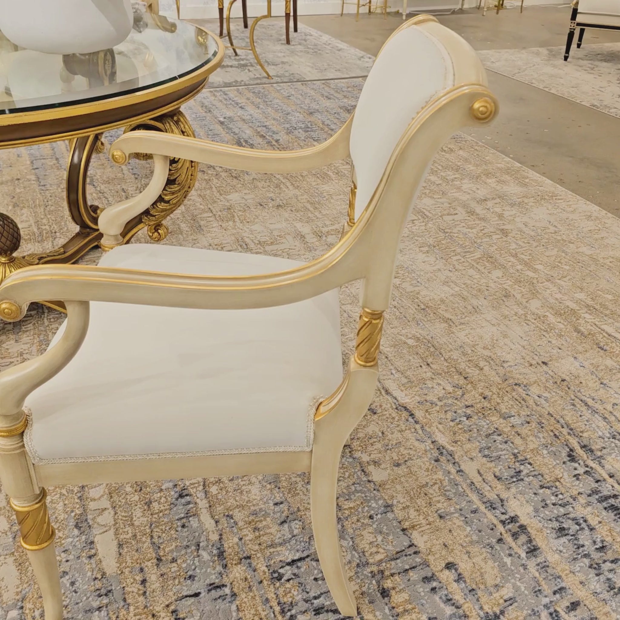 White and gold armchair with white fabric.