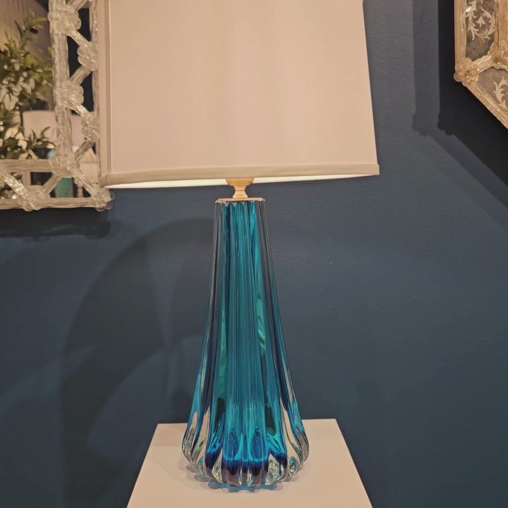 Blue Murano glass table lamp with white lamp shade.