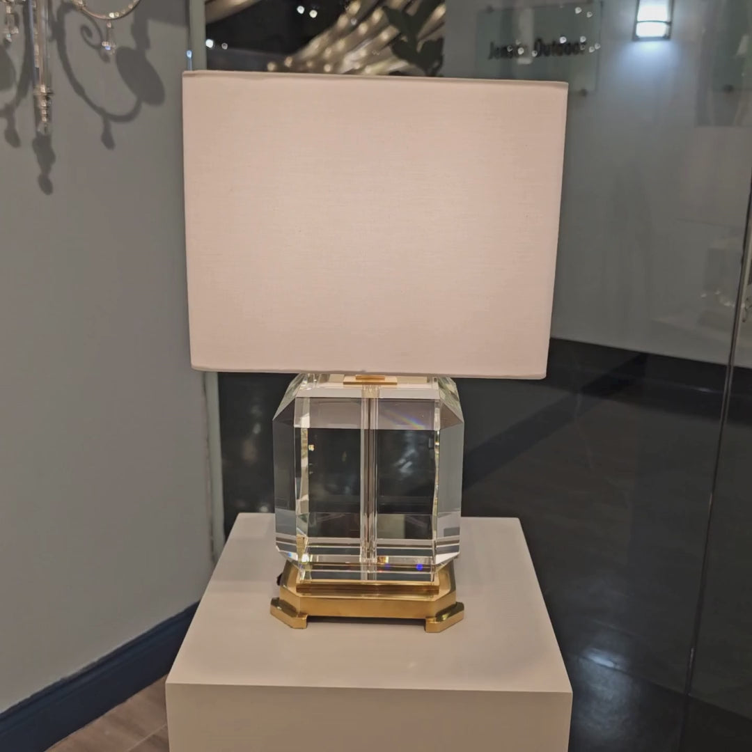 Crystal and brass table lamp with square white shade.