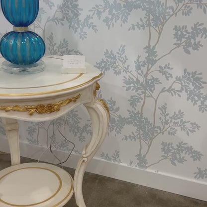 White Italian side table with gold accents.