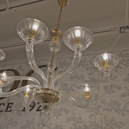 Clear Murano glass chandelier with gold accents.