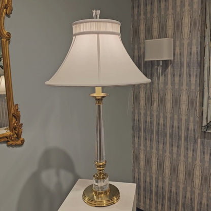 Crystal and antique brass table lamp with white shade.