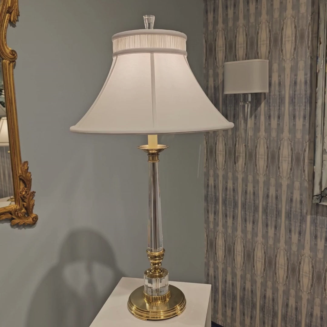 Crystal and antique brass table lamp with white shade.
