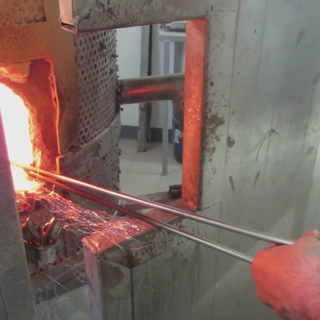 Making a Venetian glass mirror in an Italian factory.