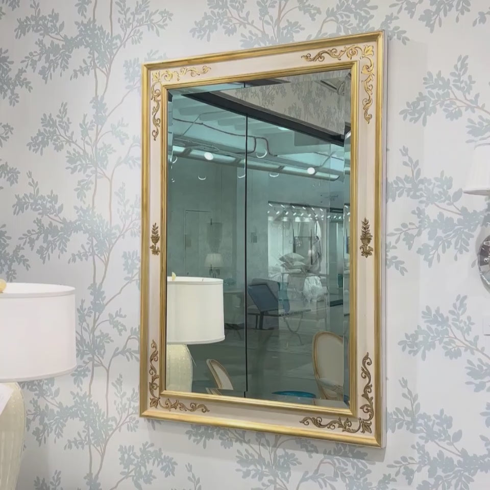 White and gold Italian mirror in luxurious showroom.