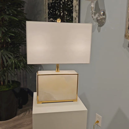 Brass and alabaster table lamp with square white shade.