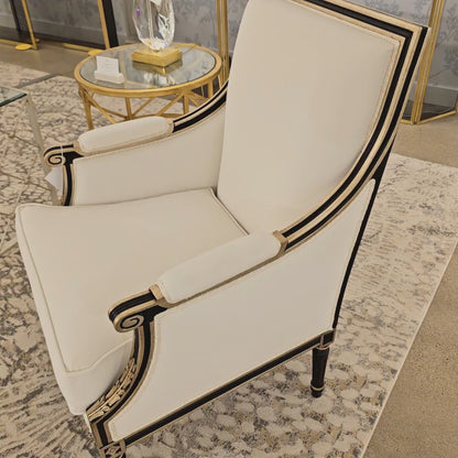 Black chair with antique silver leaf details and white fabric.