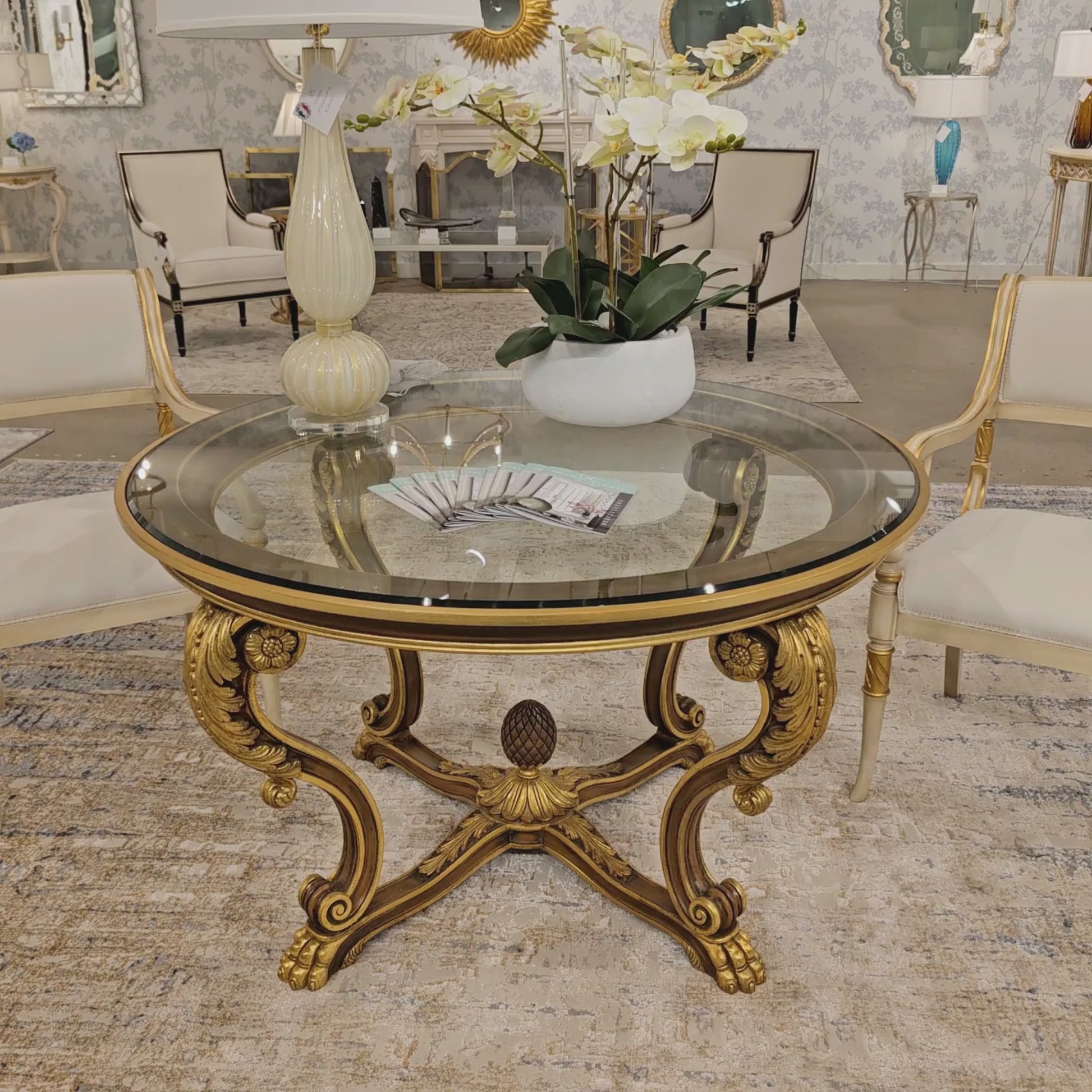 Ornate brown and gold Italian center table with glass top.