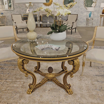 Ornate brown and gold Italian center table with glass top.