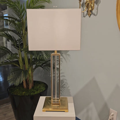 A crystal and brass lamp.