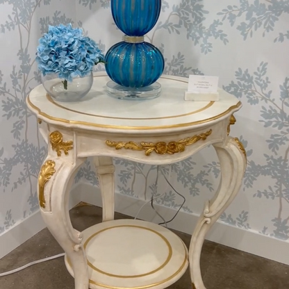 White Italian table with gold accents.