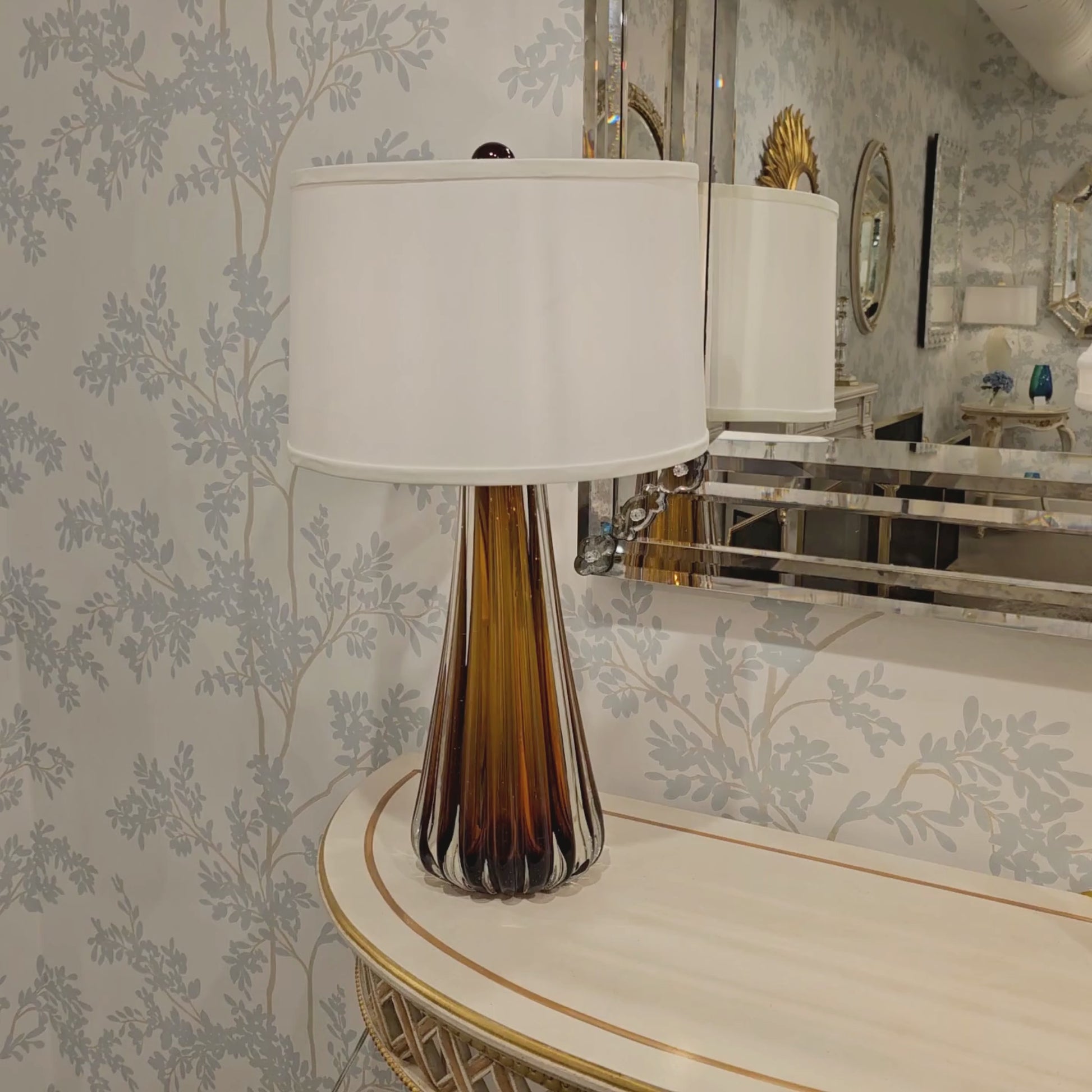 Amber Murano glass lamp with white shade.