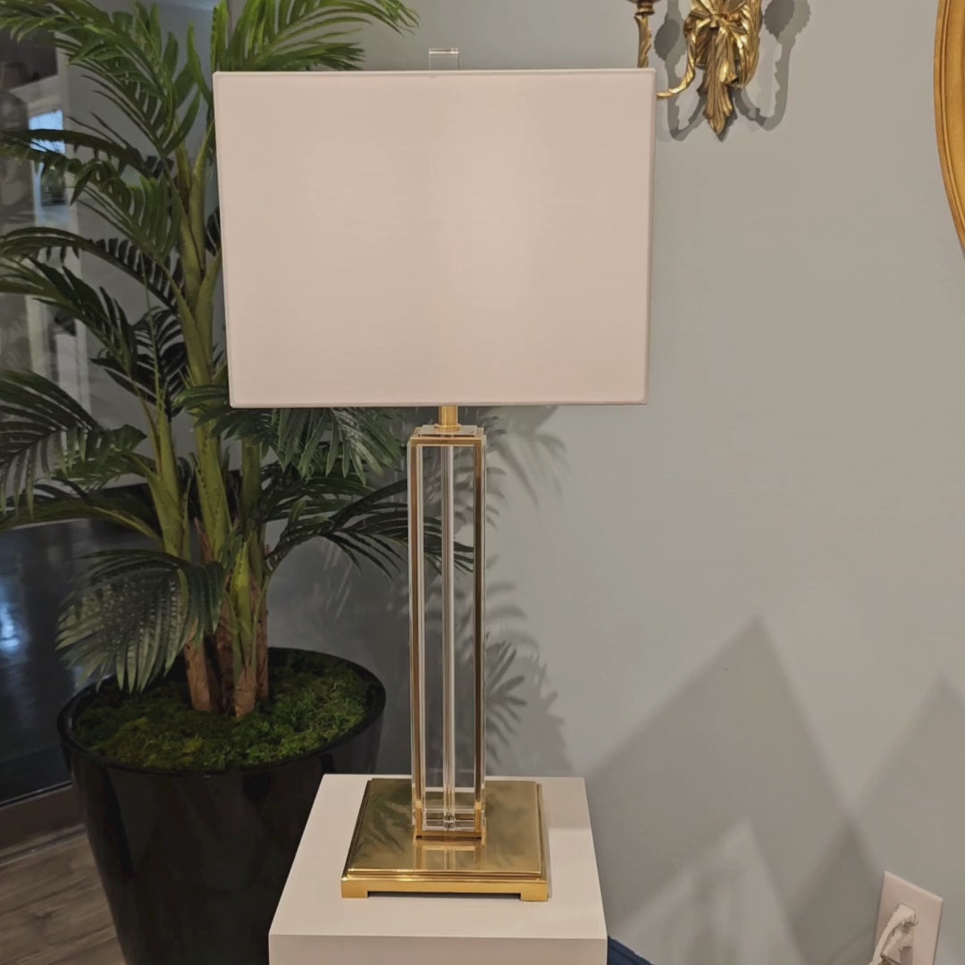 Crystal and brass table lamp with square white shade.