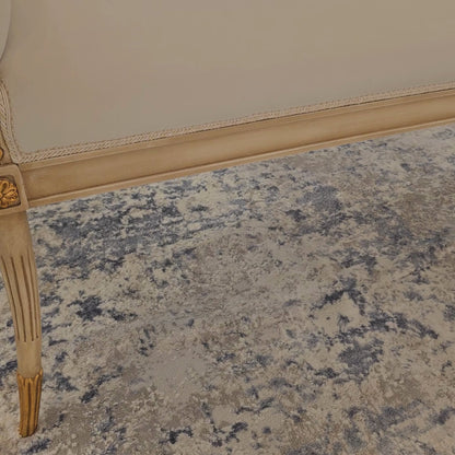 White and gold traditional upholstered bench with cream fabric.