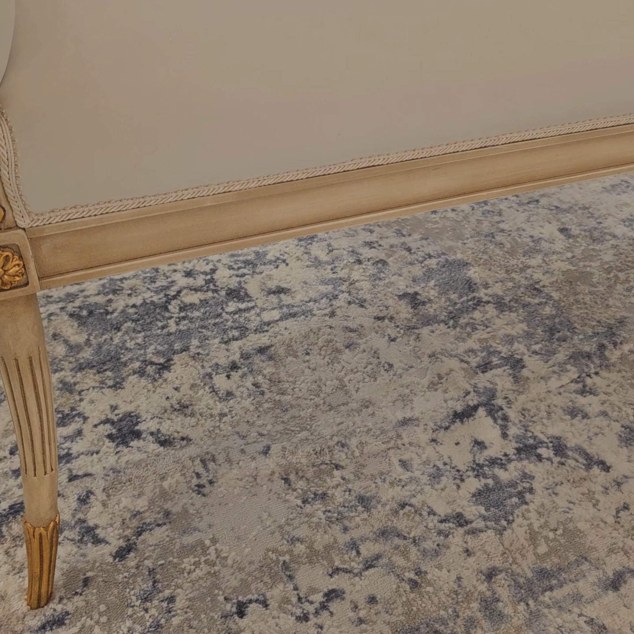 White and gold traditional upholstered bench with cream fabric.