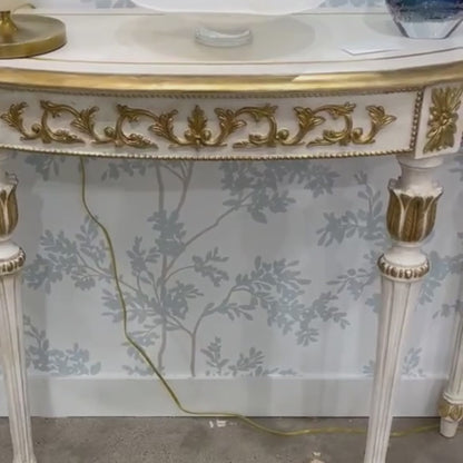 Luxury Italian white console table with carved gold details.