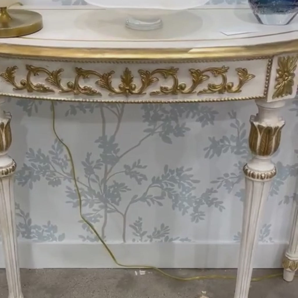Luxury Italian white console table with carved gold details.