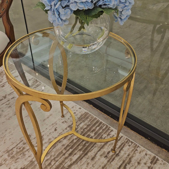 Gold side table with glass top.