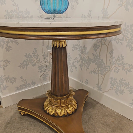 Ornate brown and gold Italian center table with white marble top.
