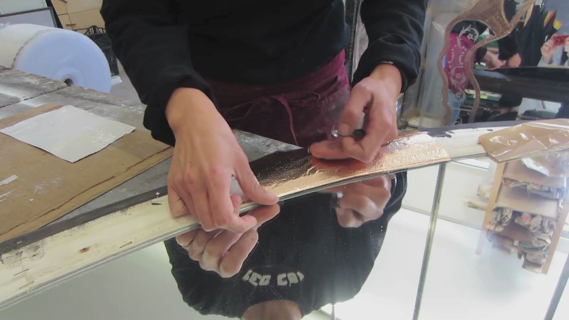Load video: Artisan applying gold leaf by hand in Murano.