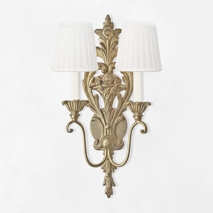 Ornate Italian silver sconce with white pleated shades.