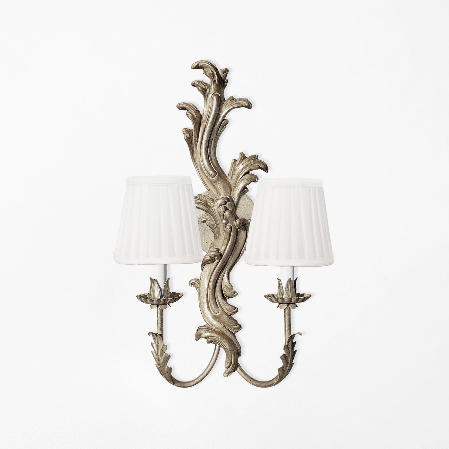Traditional silver wood sconce with white pleated shades.