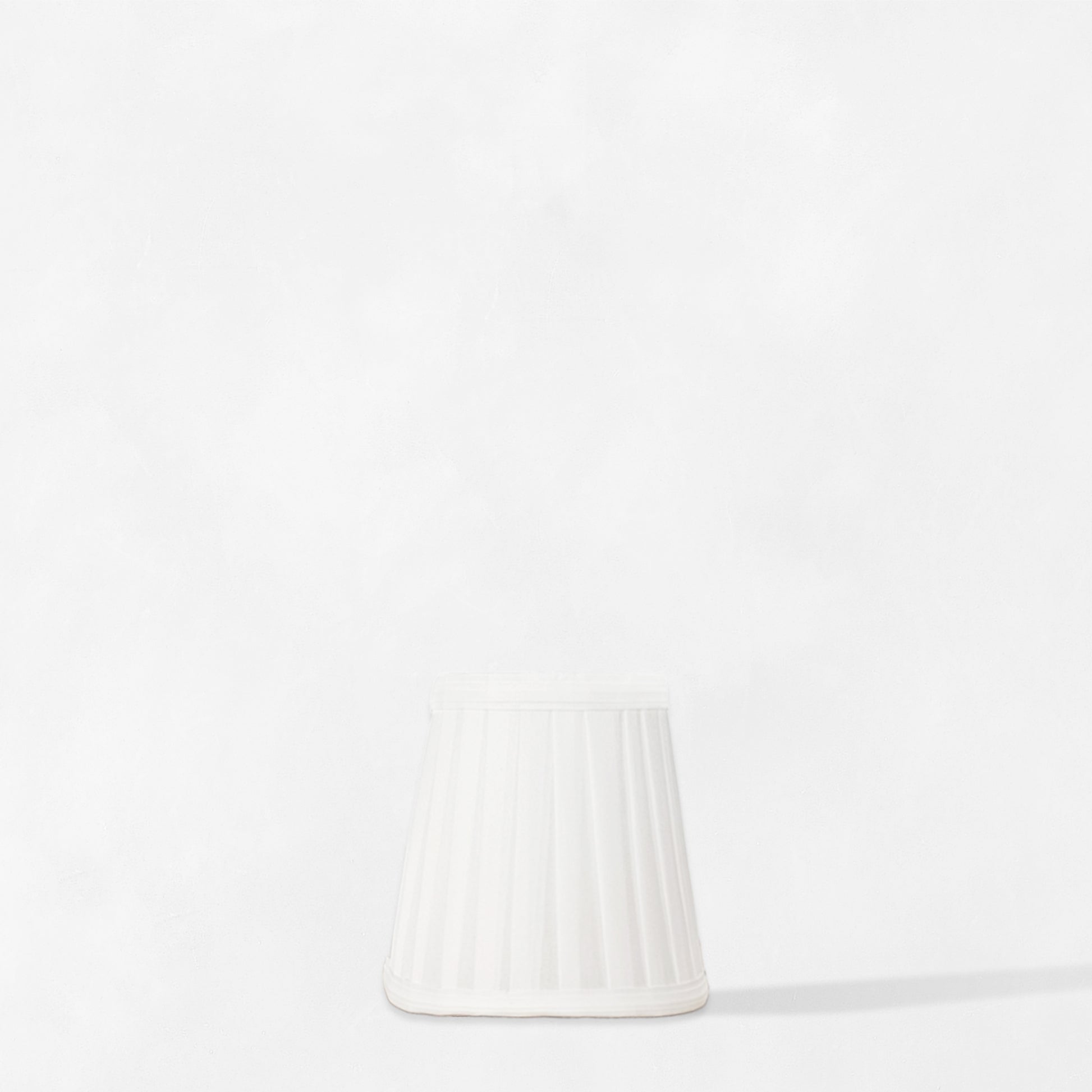 White pleated linen sconce shade.