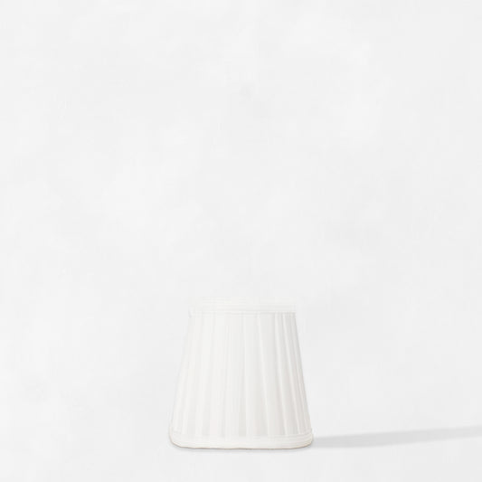 White pleated linen sconce shade.