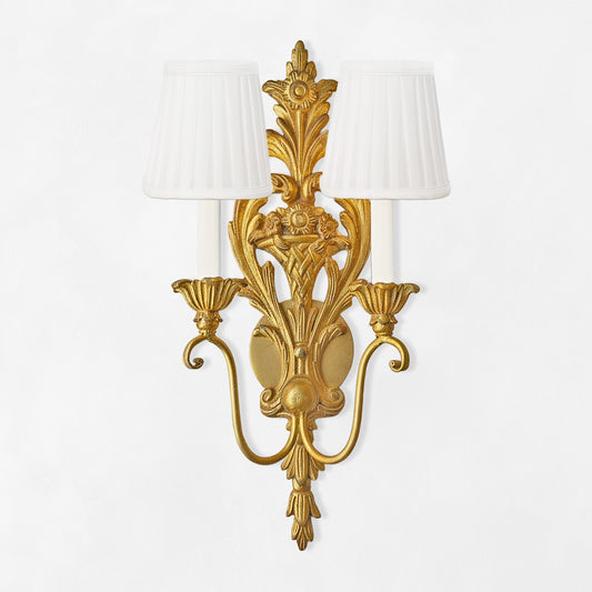 Traditional gold sconce with white pleated shades.