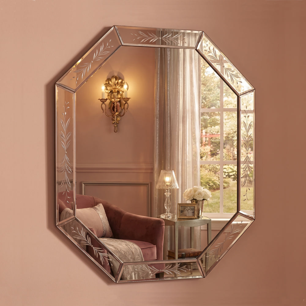 Venetian glass mirror with etched details in luxurious pink room with silver sconce and a window showing a garden.