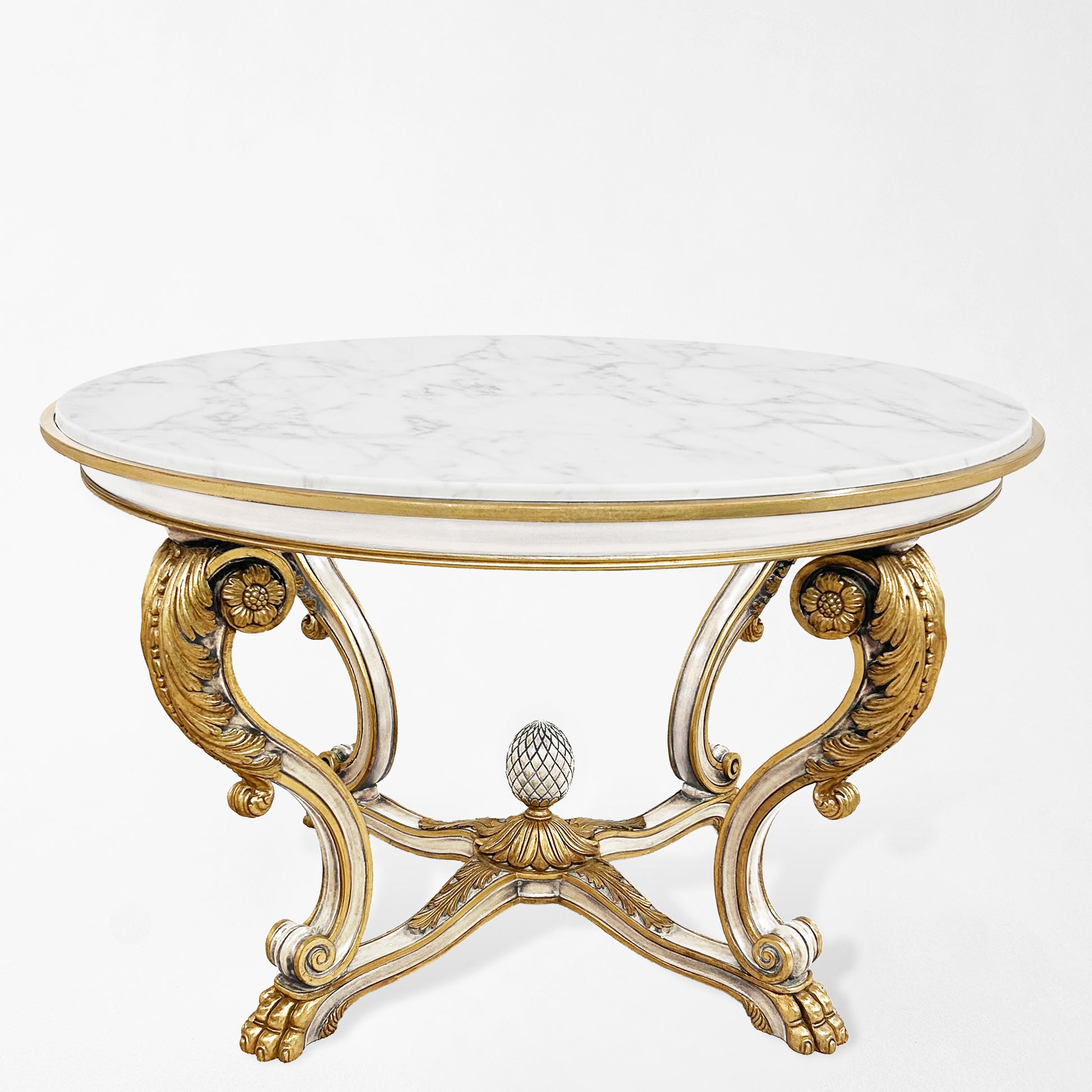 Ornate white center table with white marble top and gold details.