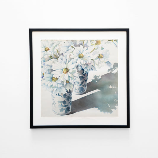 Watercolor painting of white flower in blue and white vases in a black frame.