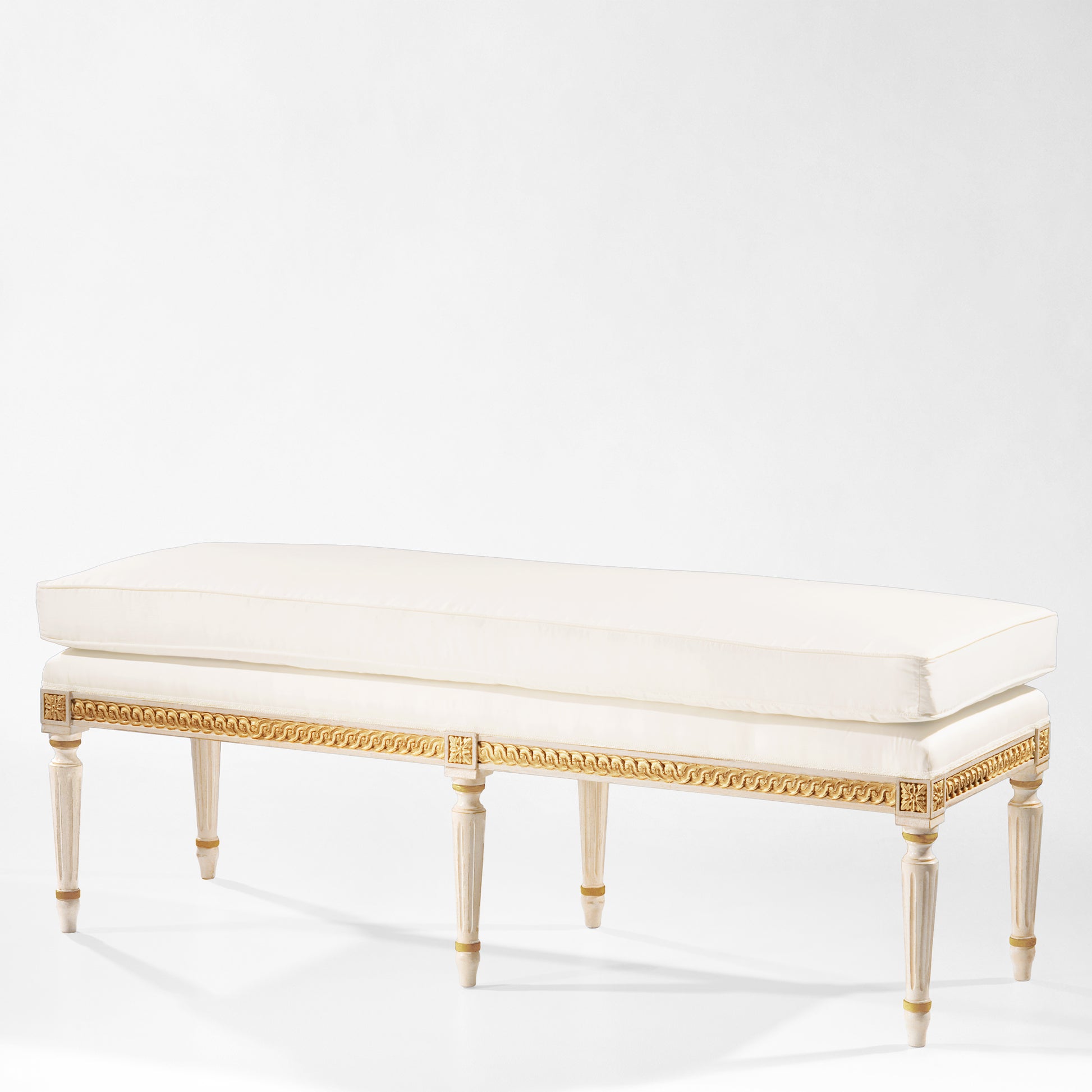 White and gold bench with white fabric.