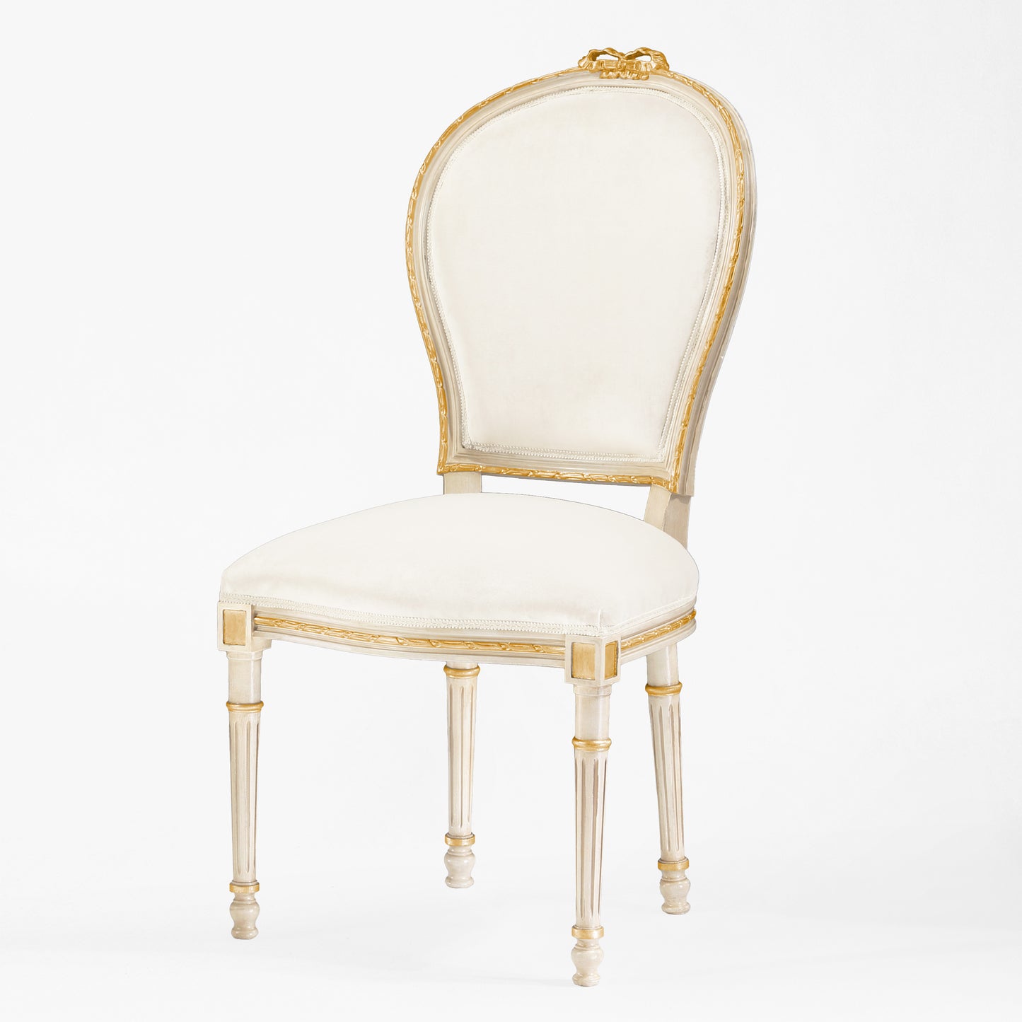 Antique white and gold chair with cream fabric.