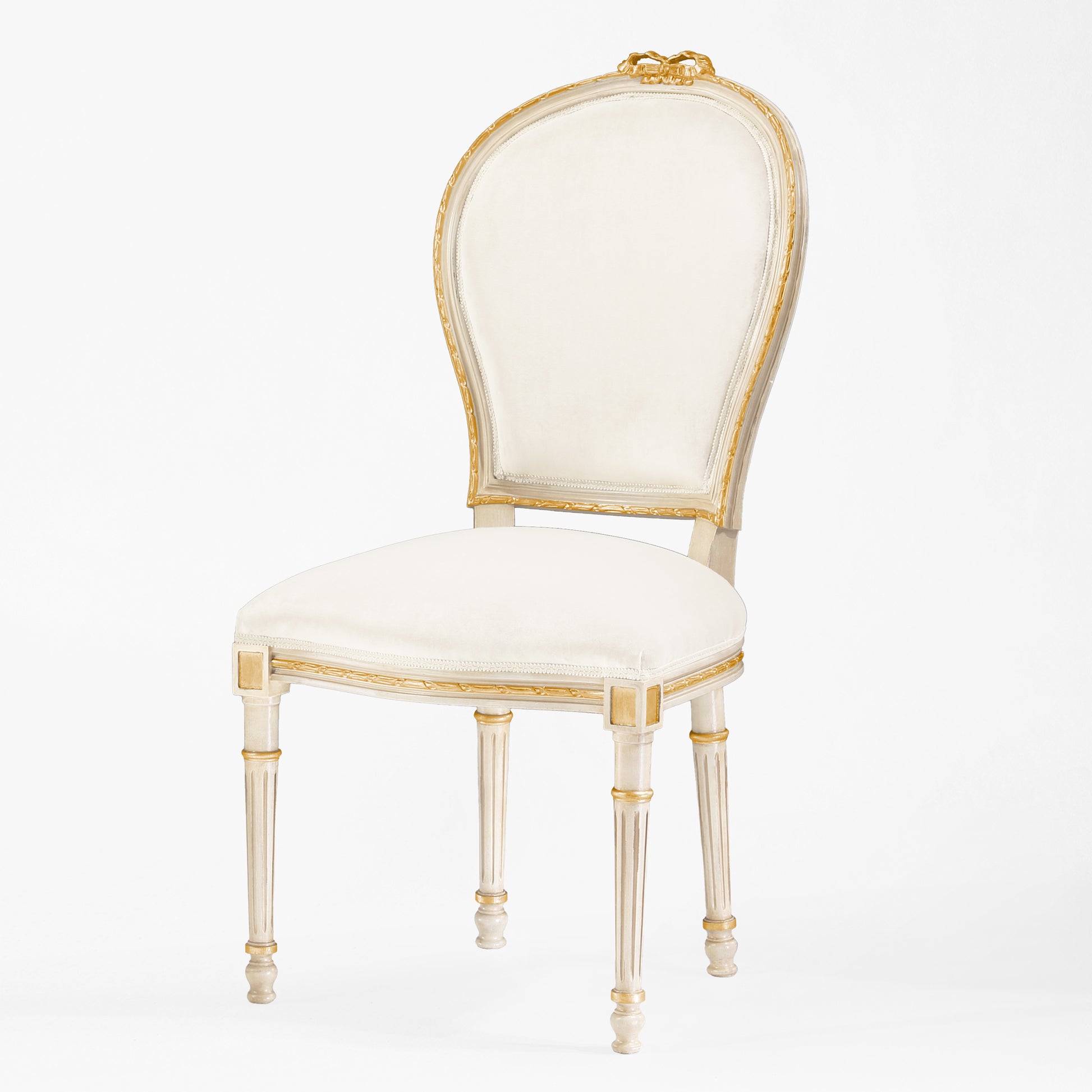 Antique white and gold chair with cream fabric.