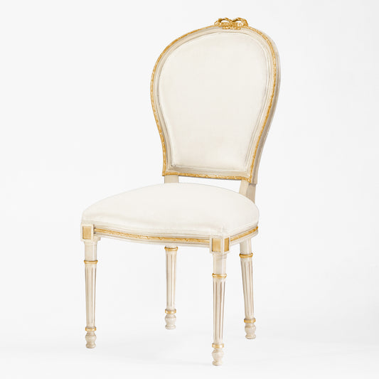 Antique white and gold chair with cream fabric.