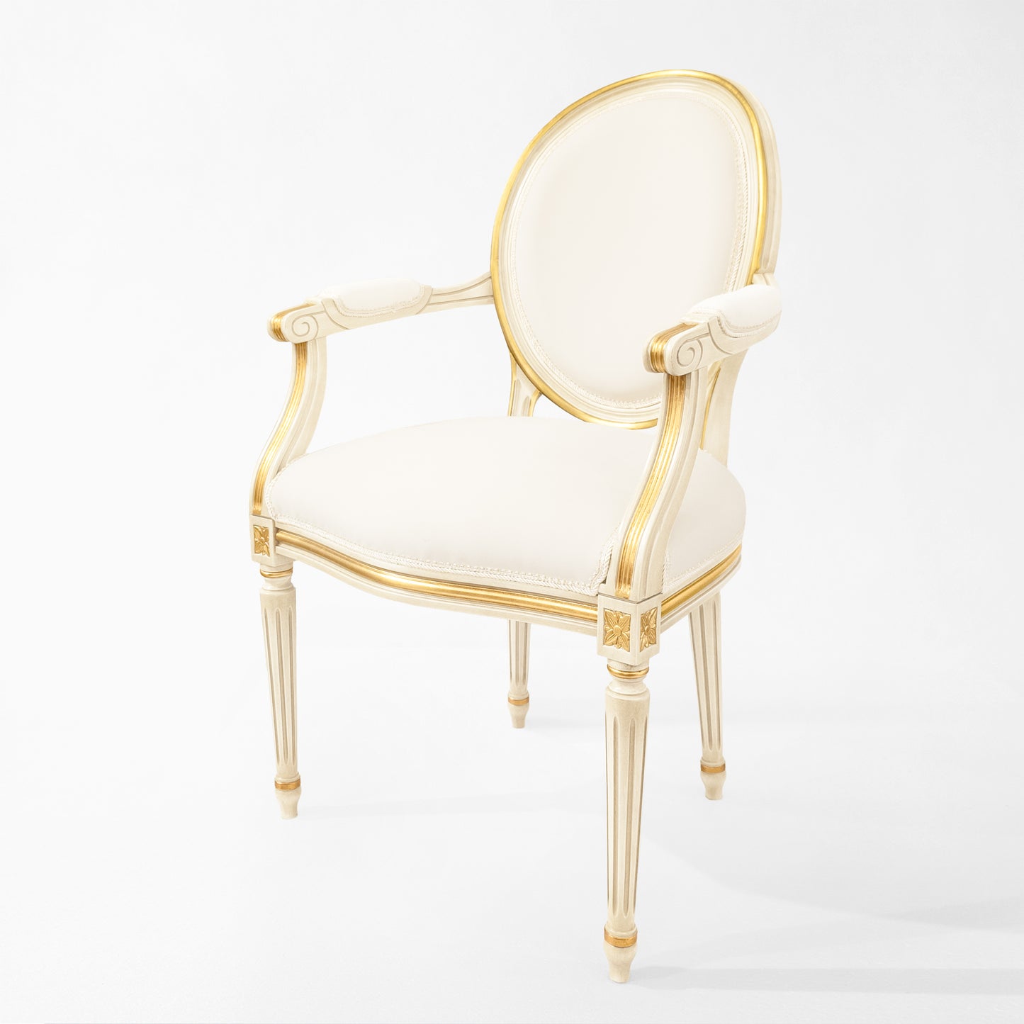 White and gold round upholstered chair with white fabric.