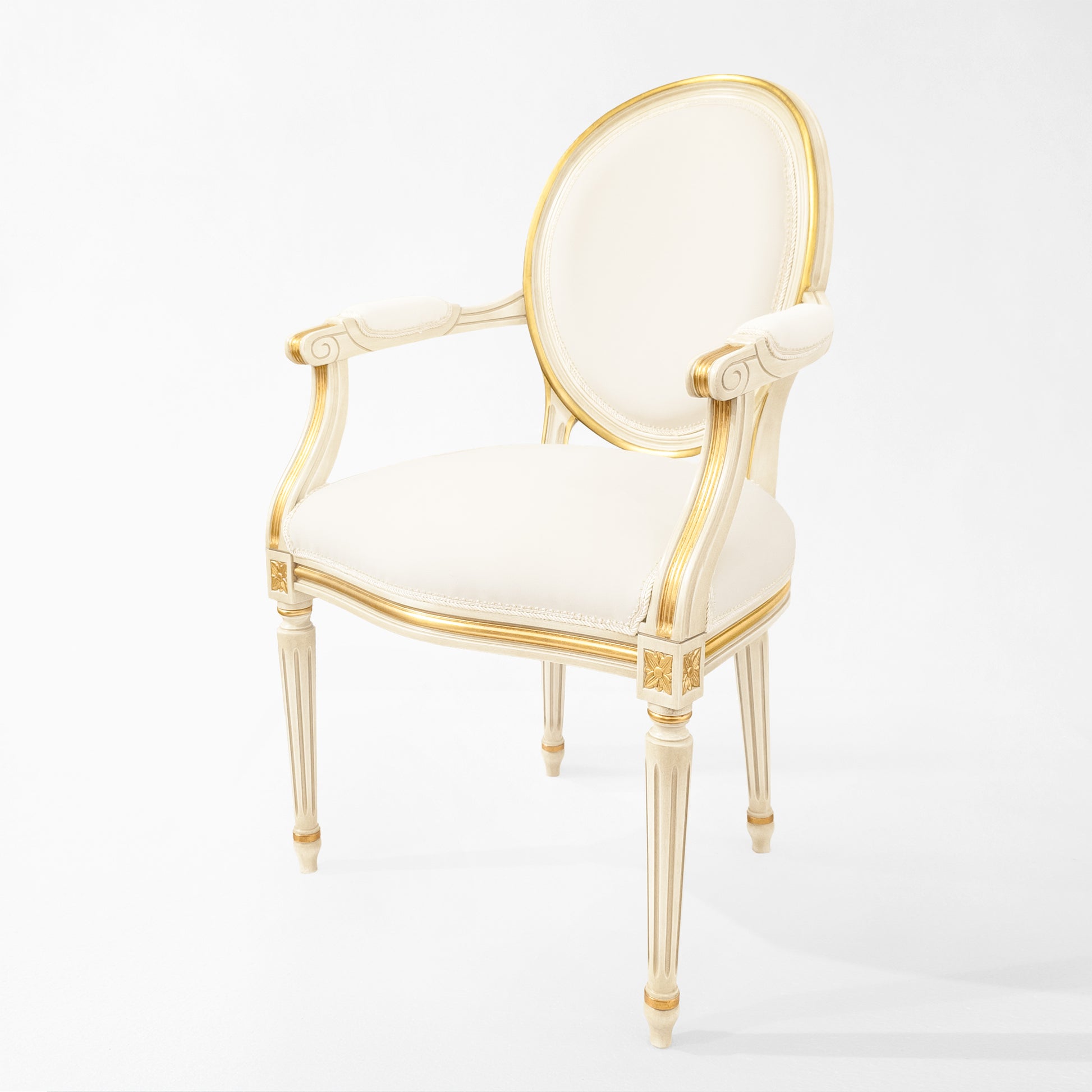 White and gold round upholstered chair with white fabric.