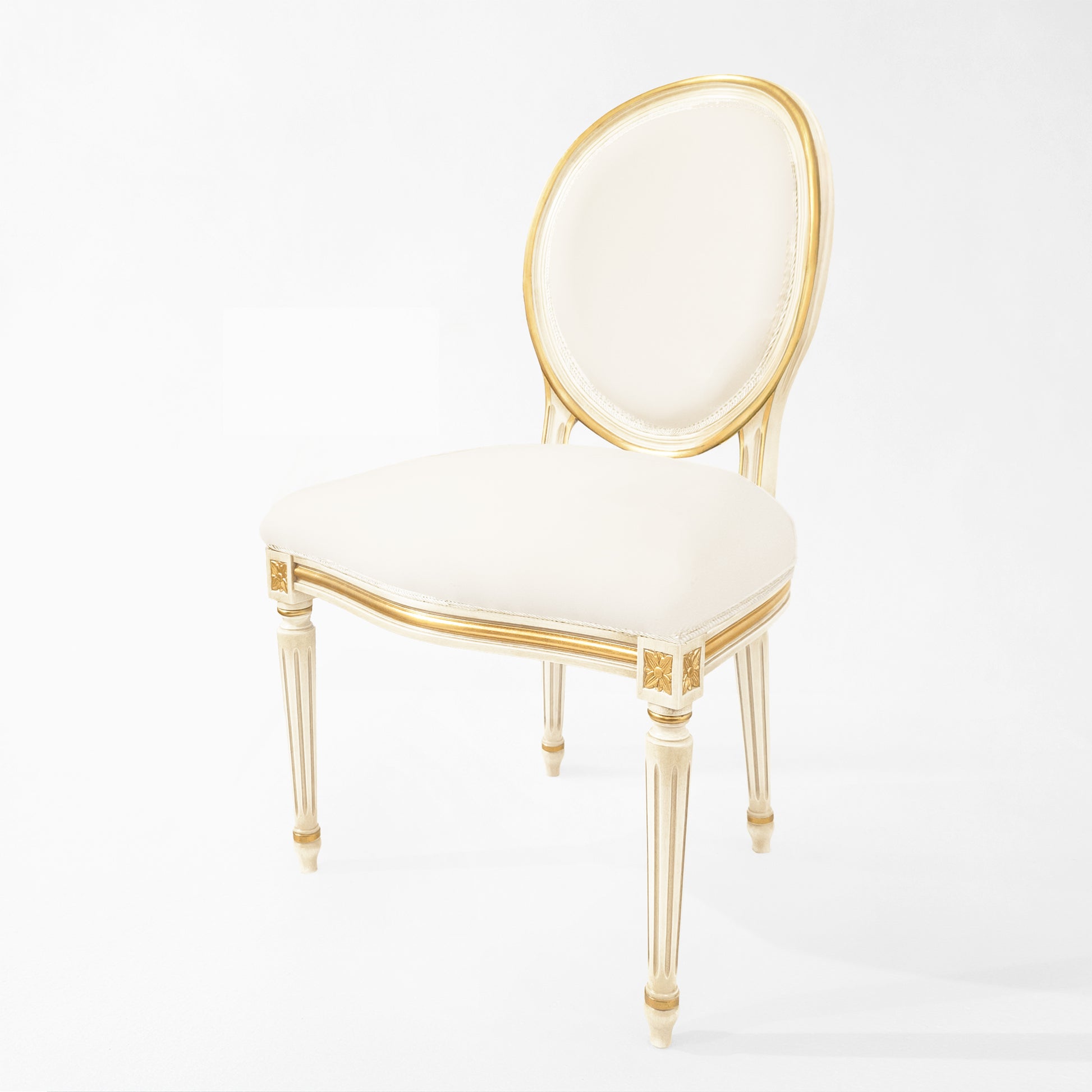 White and gold upholstered side chair with white fabric.