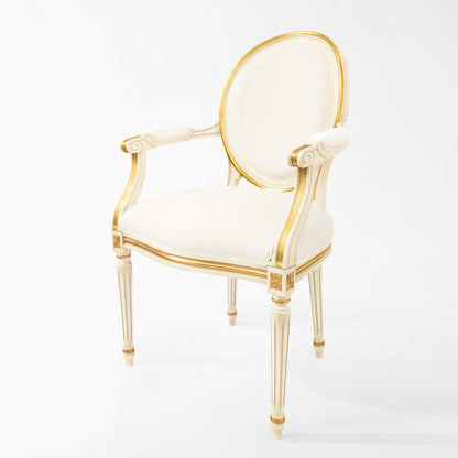Round white and gold chair with white fabric.