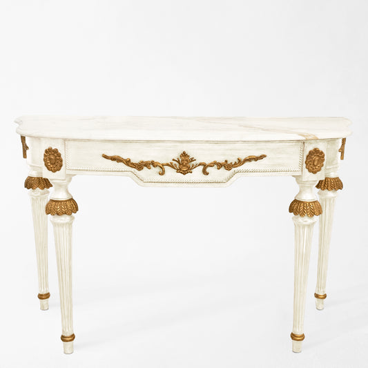 Ornate white console with gold details and white marble.