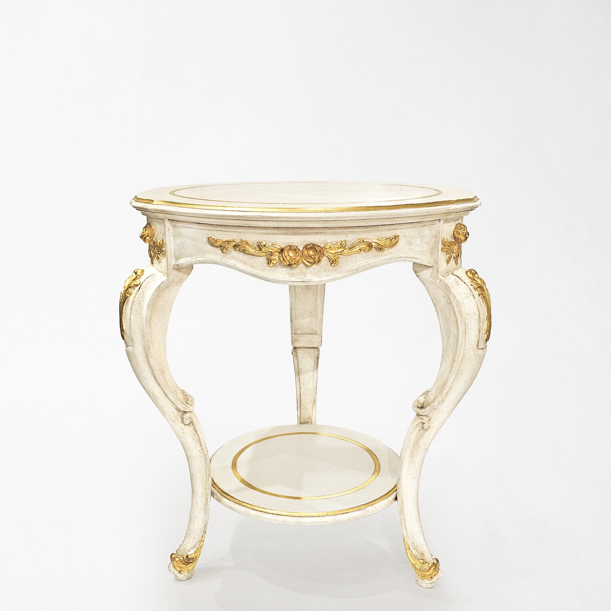 Round traditional white table with gold details.
