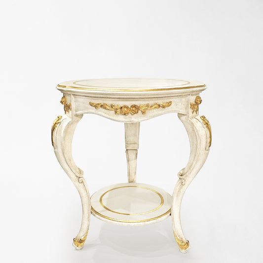Round traditional white table with gold details.