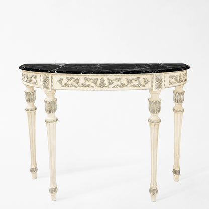 Ornate white and silver Italian console table with black marble top.