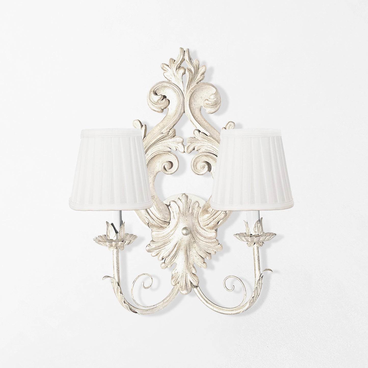 Traditional white wood sconce with white pleated shades.